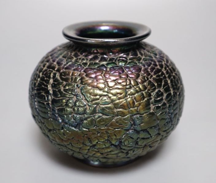 An iridescent black glass vase, squat globular form, 10cm